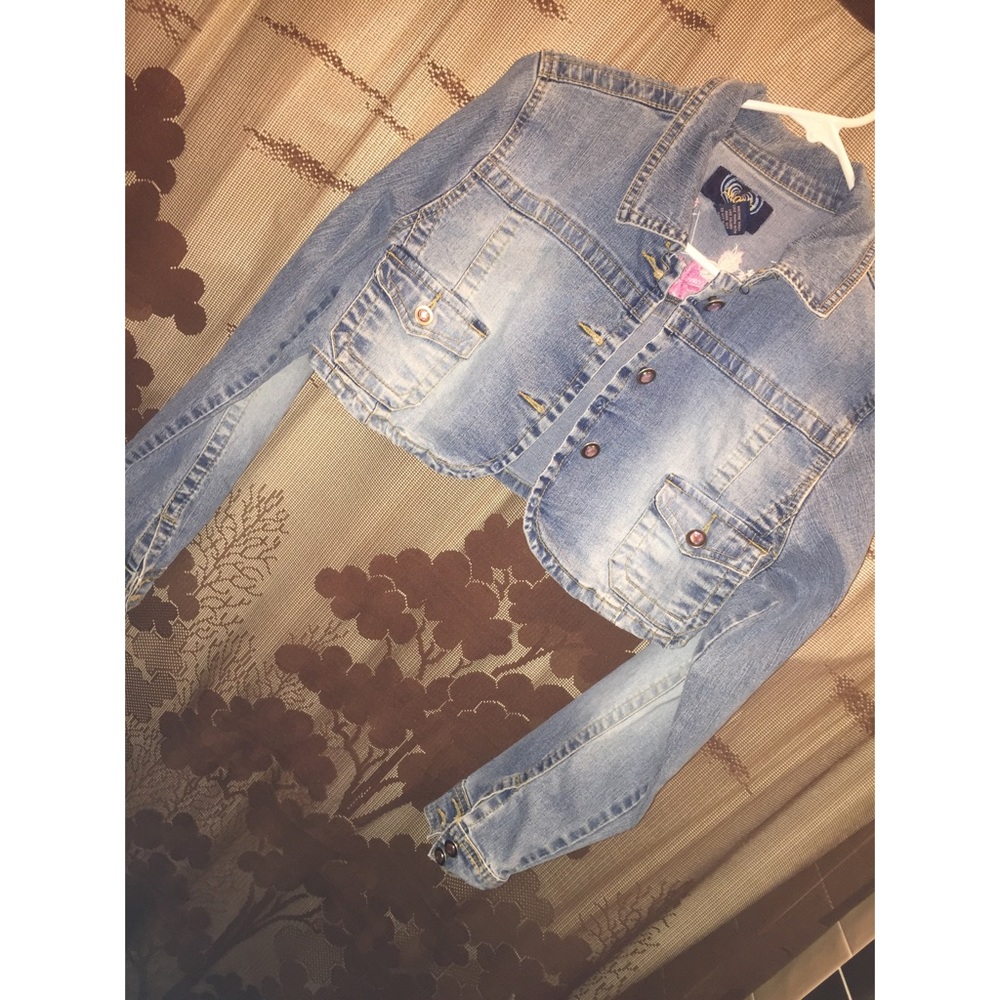 Jean jacket with pink floral detailing.